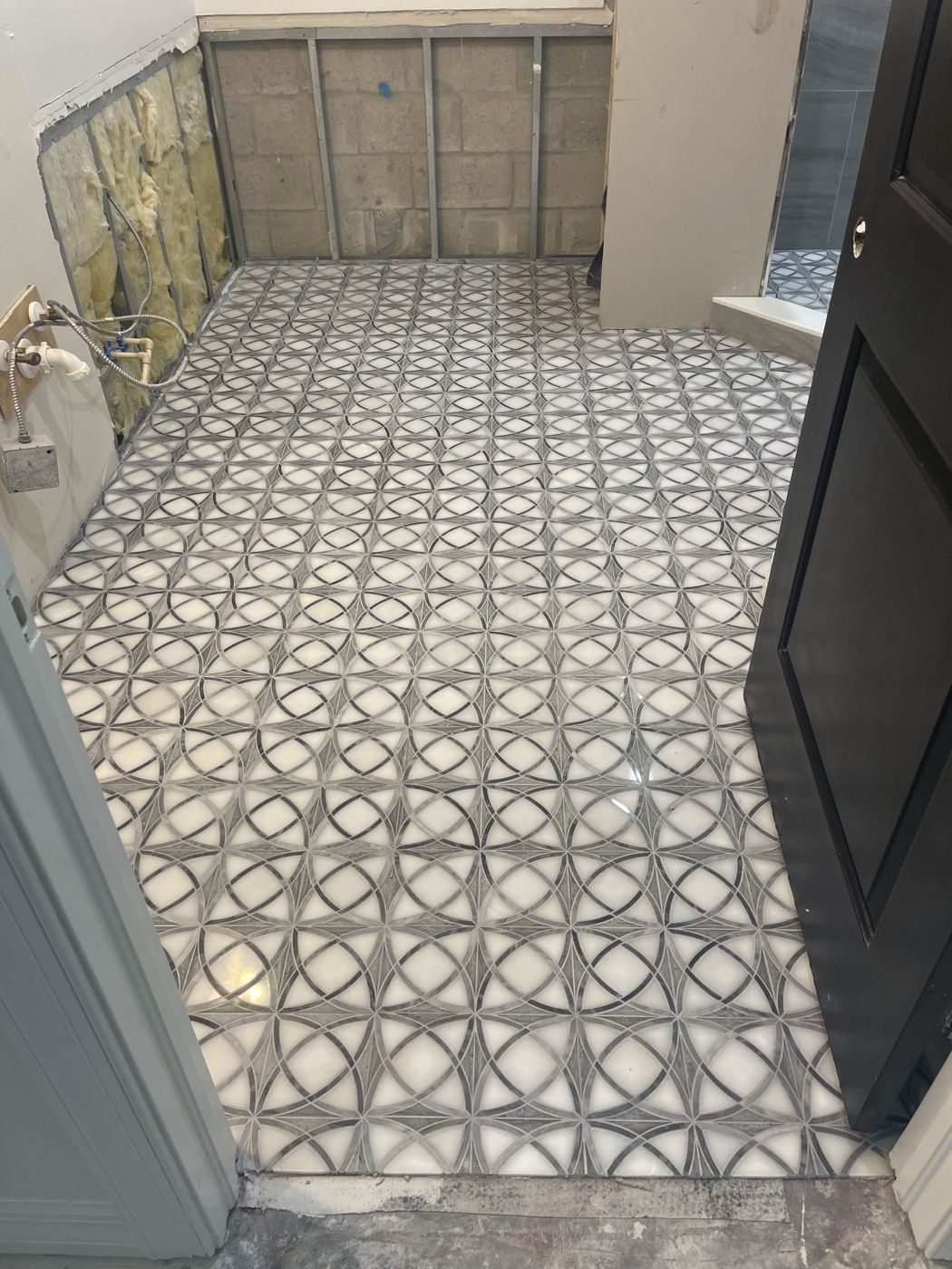 Patterned porcelain tile floor installed in a hallway